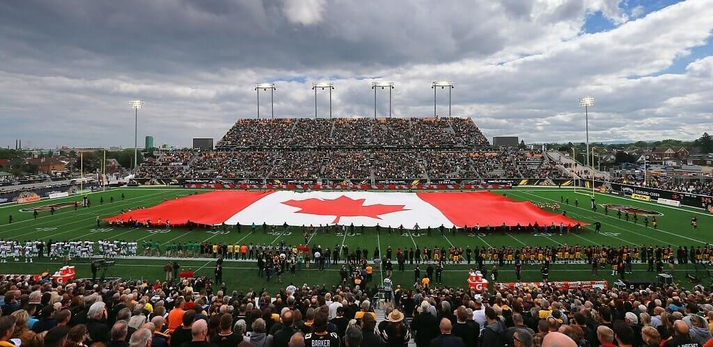 Canadian flag spread over the stadium field